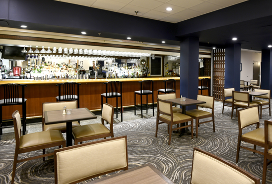 a restaurant with tables, chairs, and a bar